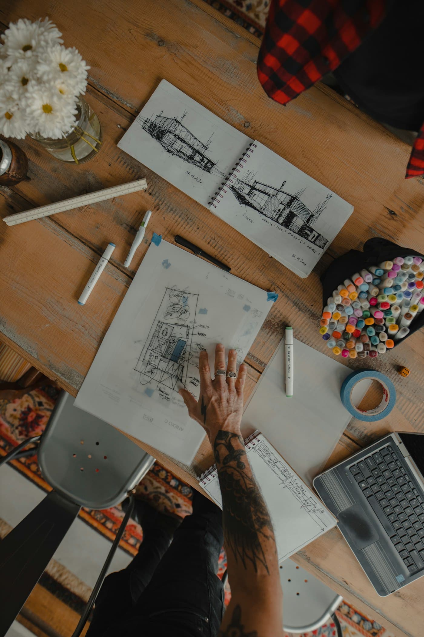 Architectural sketches on a desk seen from above